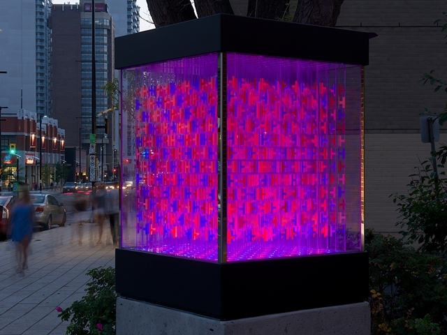 A glass cube with an interior of glass strips illuminated with LEDs.