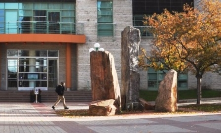 A cairn standing in front of City Hall.