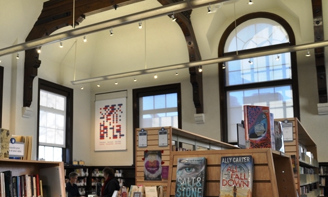 An image printed on nylon hangs on a library wall.