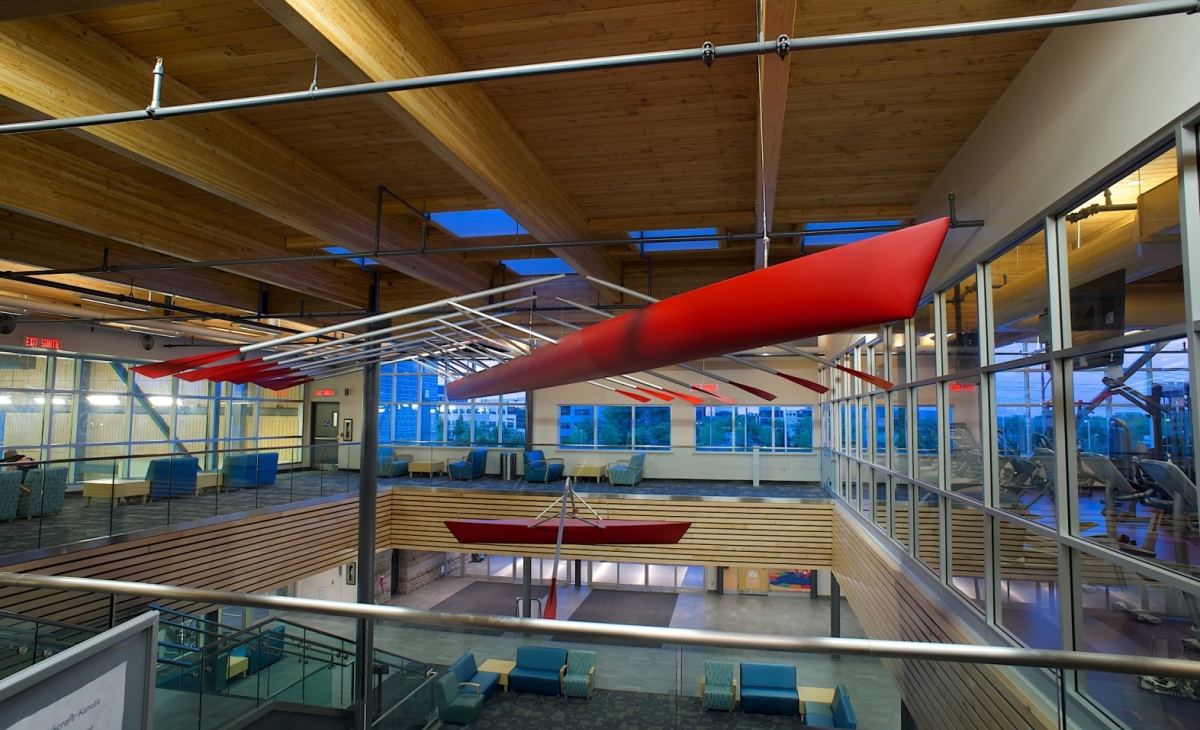 A statue made of granite, glass, and steel depicting two figures working together to lift building material.